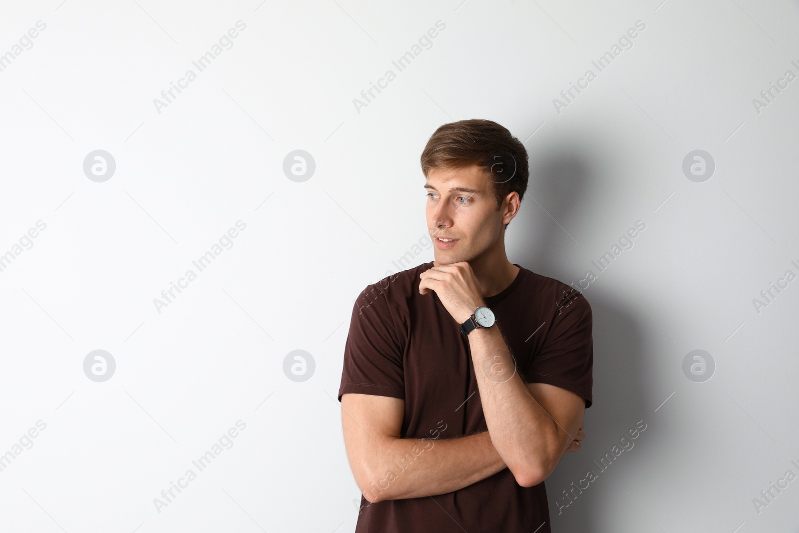 Photo of Portrait of handsome man on light background. Space for text