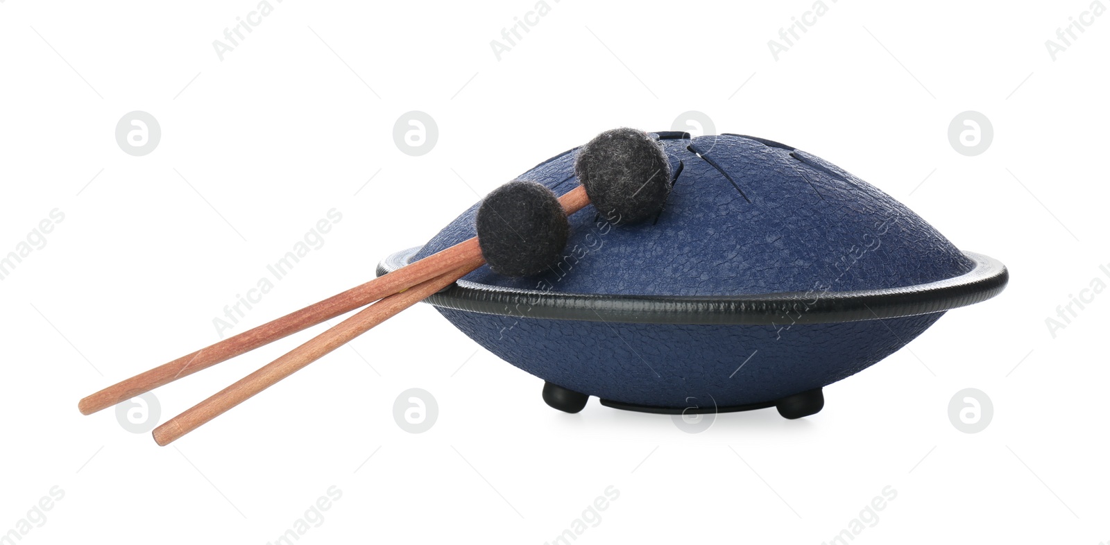 Photo of Steel tongue drum with soft mallets on white background. Percussion musical instrument