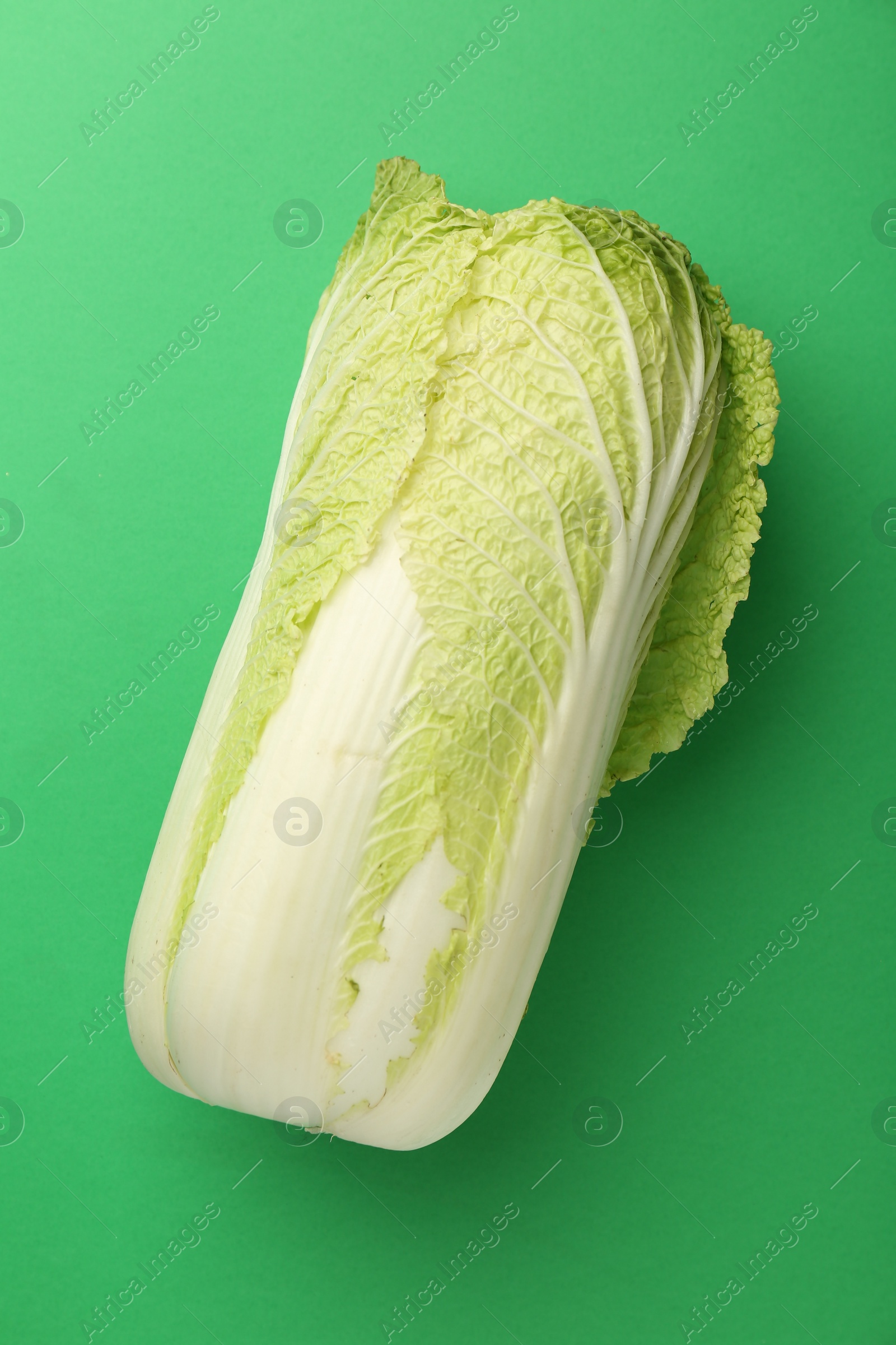 Photo of Fresh ripe Chinese cabbage on green background, top view