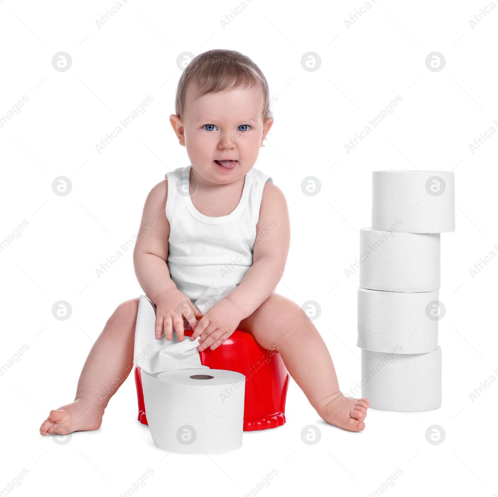 Photo of Little child sitting on baby potty and stack of toilet paper rolls against white background