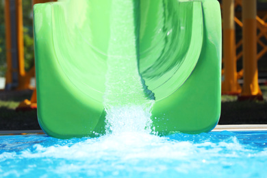 Photo of Green slide in water park. Summer vacation
