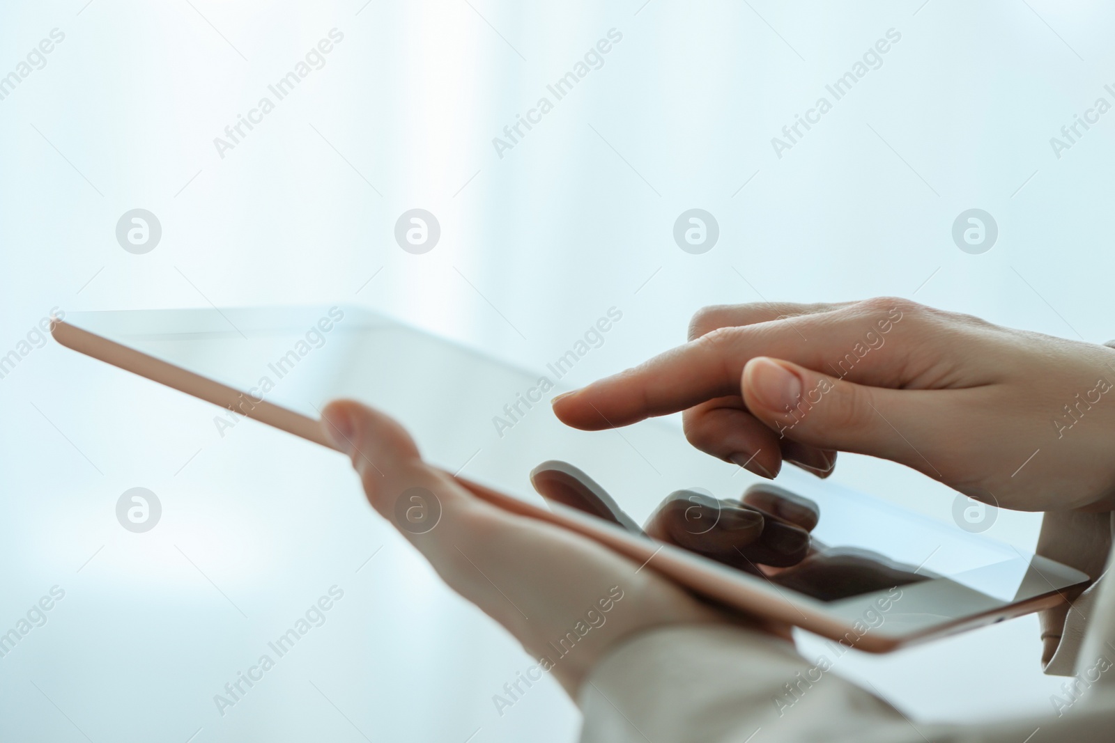 Photo of Closeup view of woman using modern tablet on blurred background