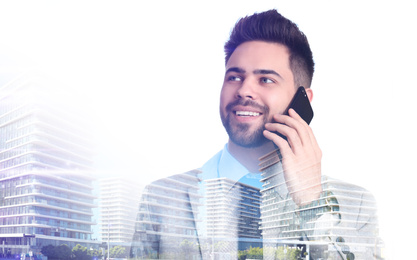 Double exposure of businessman talking on phone and city landscape