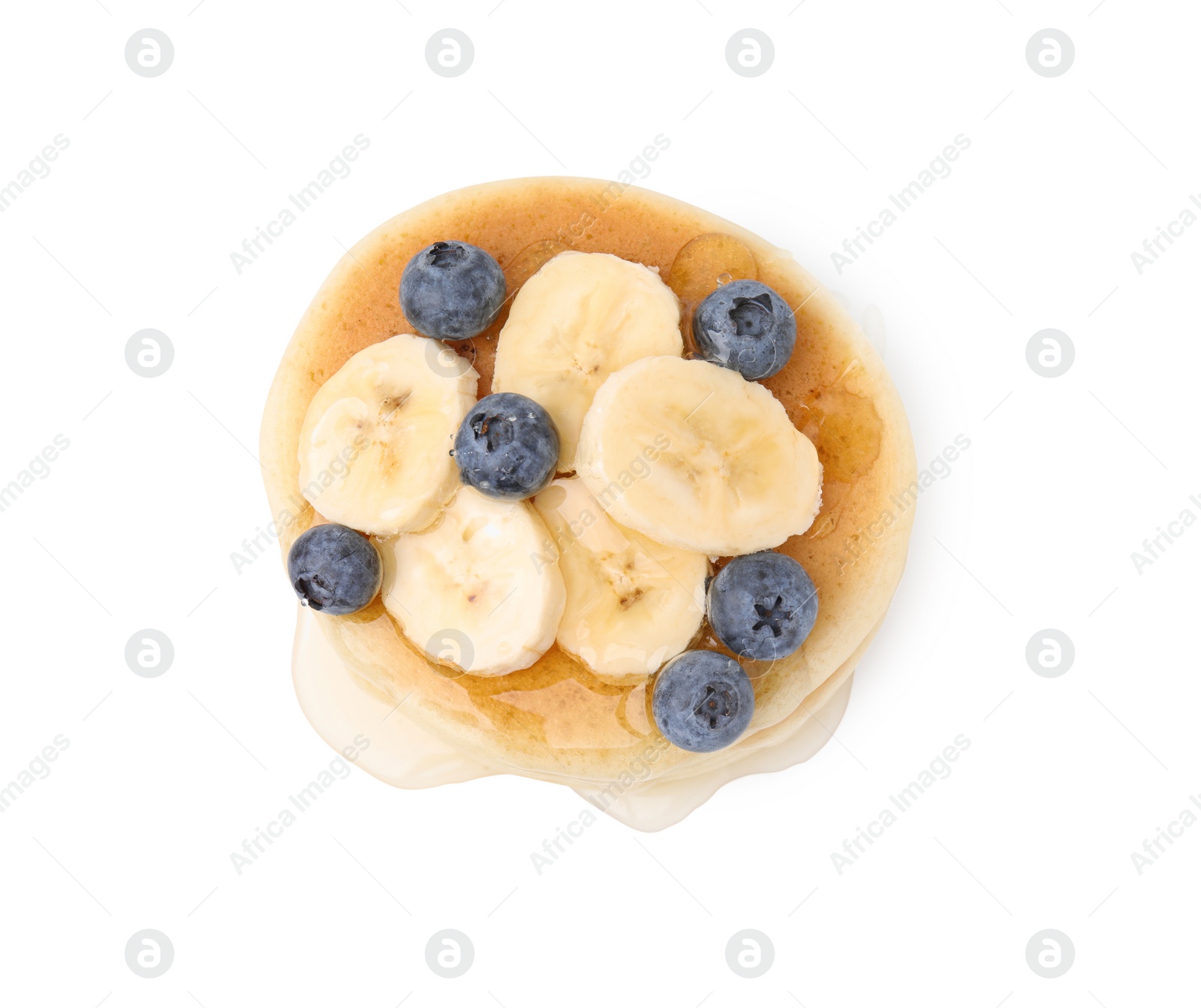 Photo of Delicious pancake with banana slices, blueberries and honey isolated on white, top view