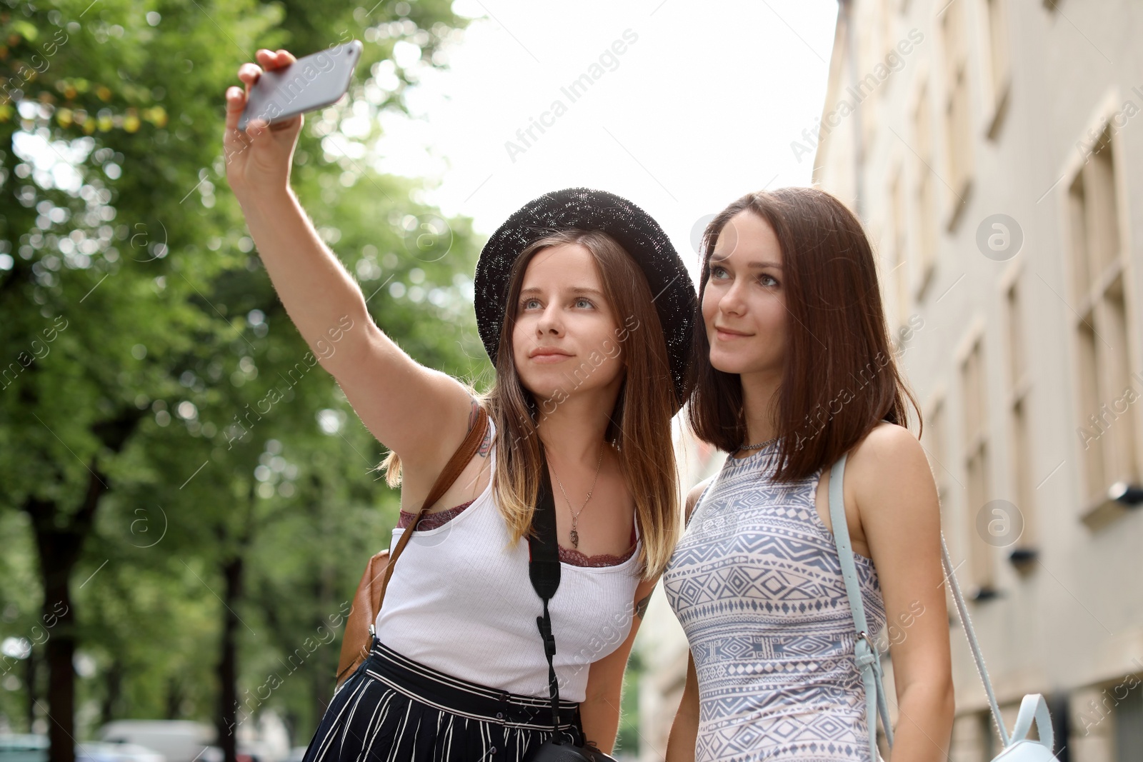 Photo of Young women taking selfie on city street