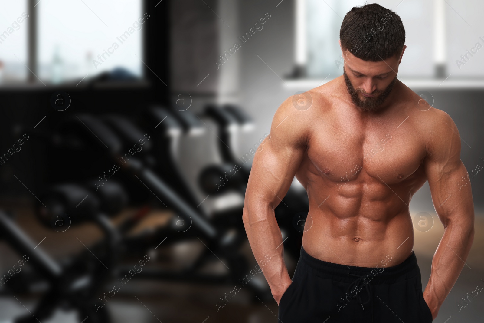 Image of Handsome bodybuilder with muscular body in gym, space for text