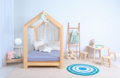 View of cozy child's room interior with cute bed