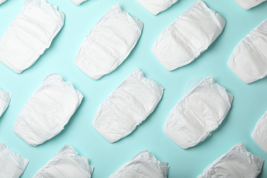 Photo of Flat lay composition with baby diapers on light blue background