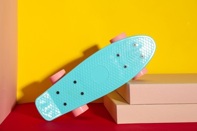 Photo of Turquoise skateboard on color background. Sport equipment