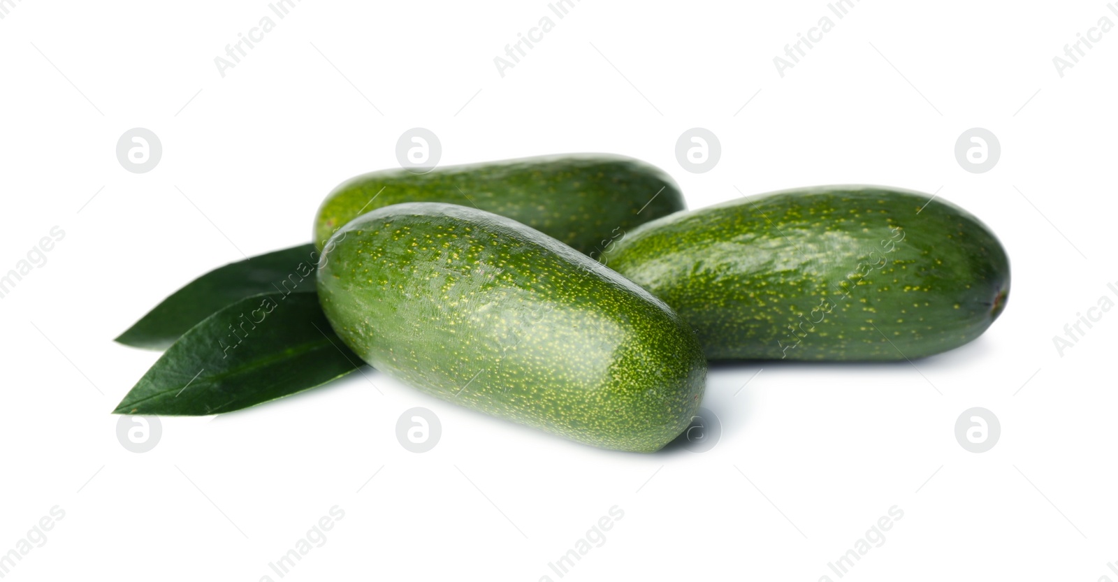 Photo of Fresh whole seedless avocados with leaves isolated on white