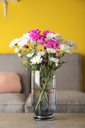 Beautiful bouquet of Chrysanthemum flowers on grey table indoors. Interior design