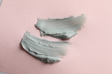 Samples of face mask on pink background, flat lay