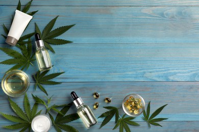 Photo of Flat lay composition with hemp leaves, CBD oil and THC tincture on light blue wooden table, space for text