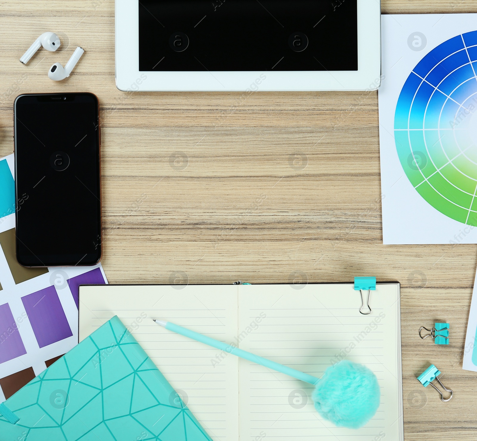 Photo of Flat lay composition with digital devices and color palettes on wooden background, space for text. Graphic designer's workplace