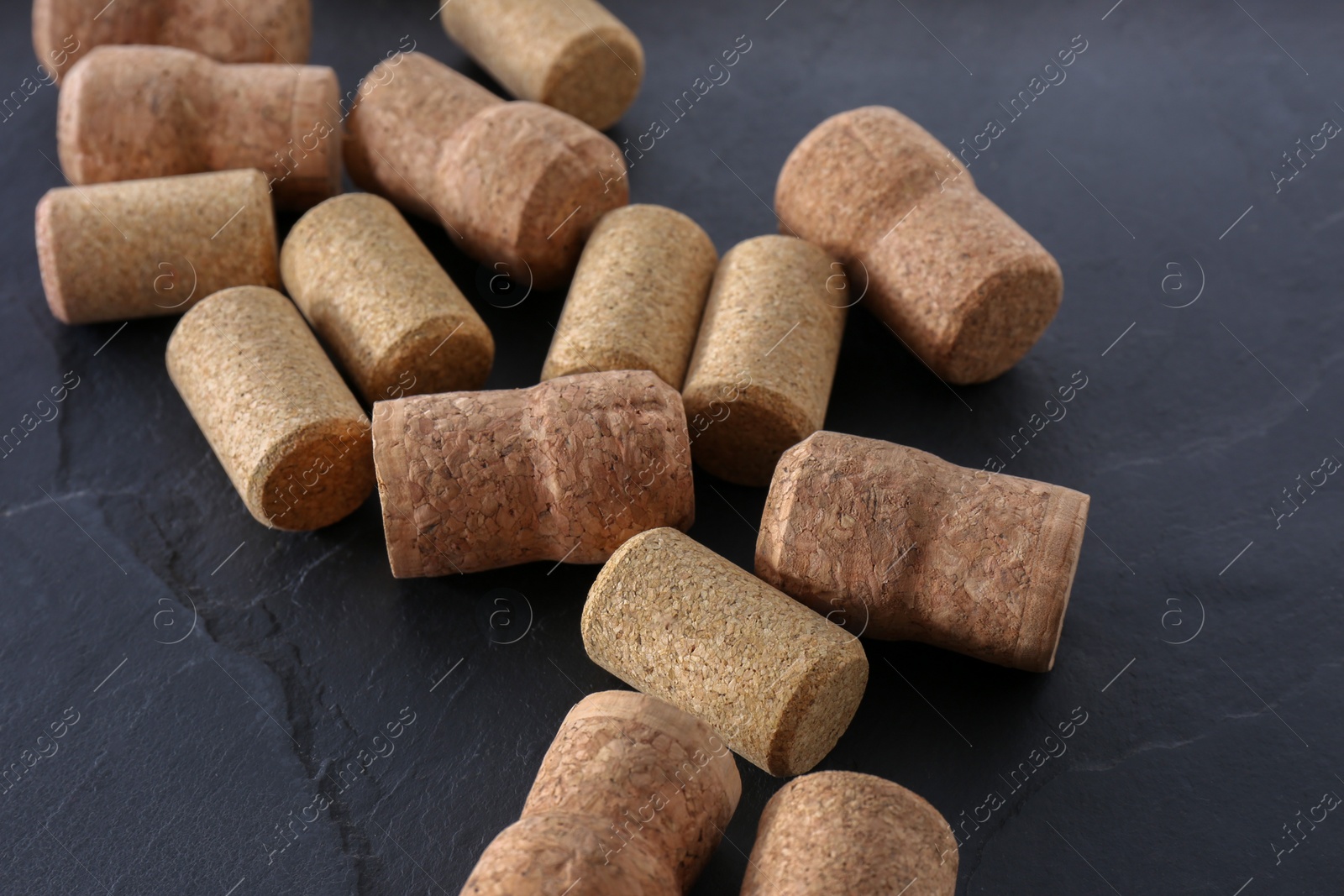 Photo of Many wine bottle corks on black table