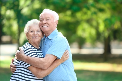 Photo of Portrait of cute elderly couple in park
