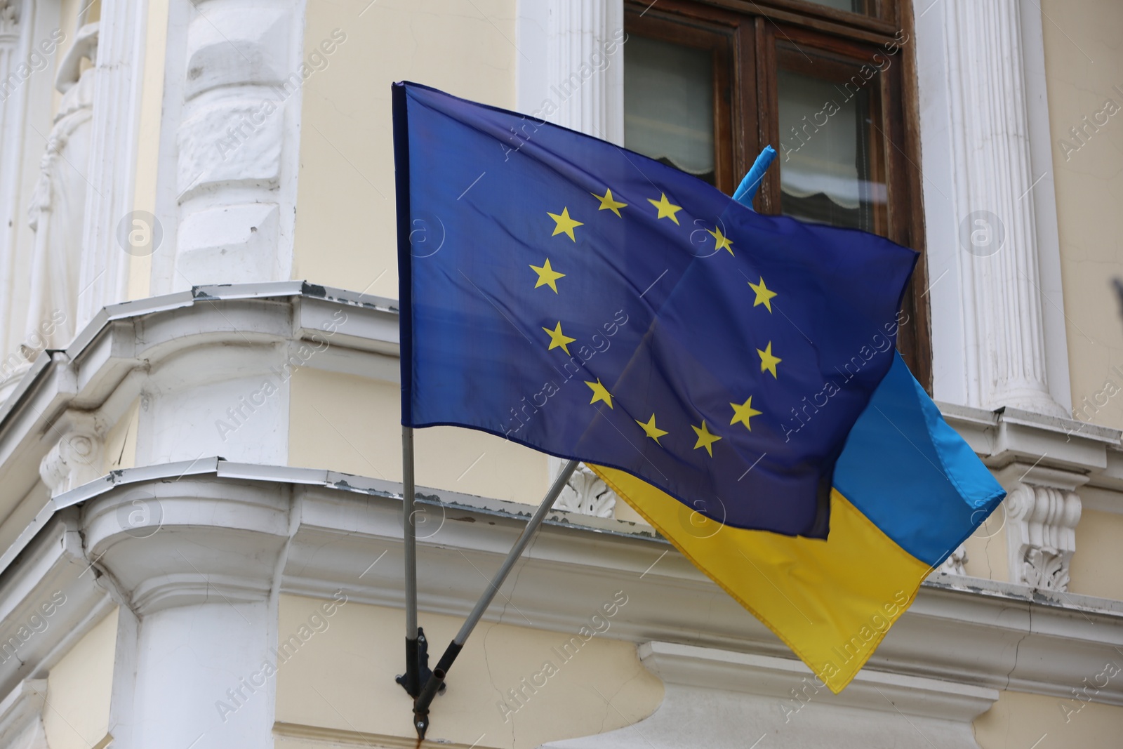 Photo of Flags of Ukraine and European Union on building facade