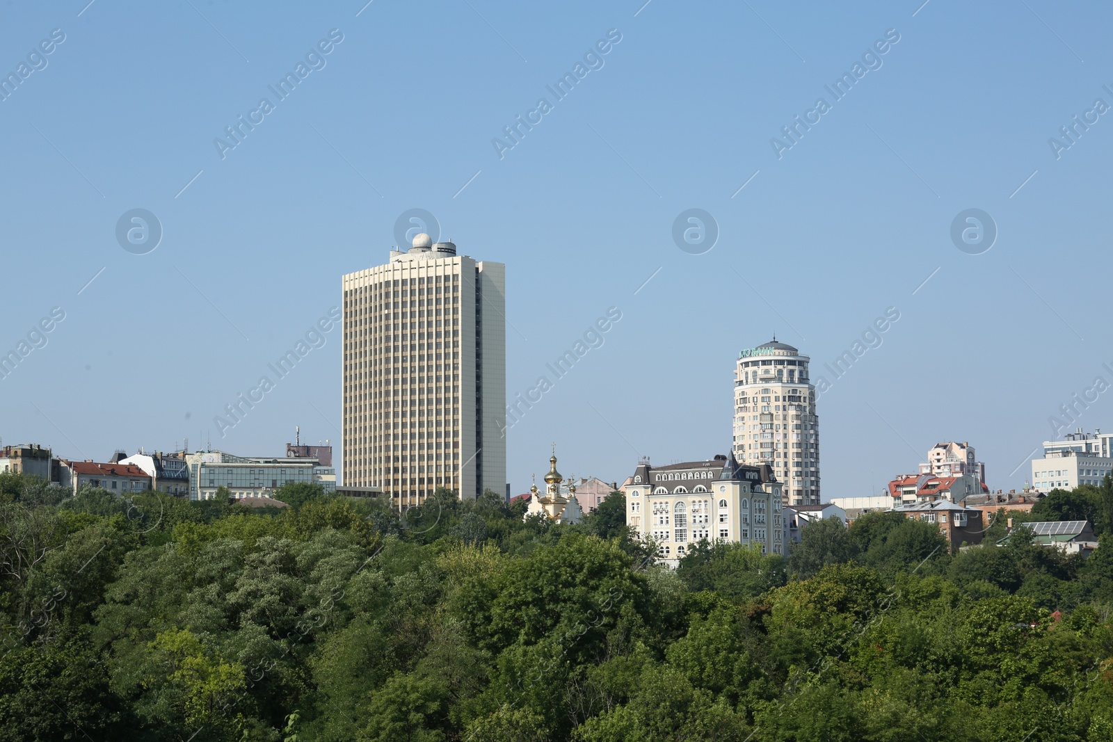 Photo of View of beautiful city with buildings and trees on sunny day