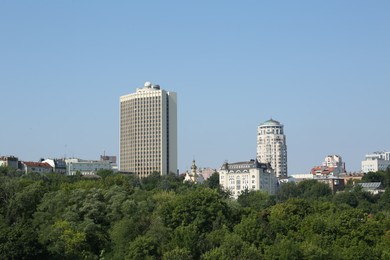 View of beautiful city with buildings and trees on sunny day