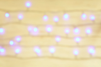 Photo of Blurred view of glowing Christmas lights as background