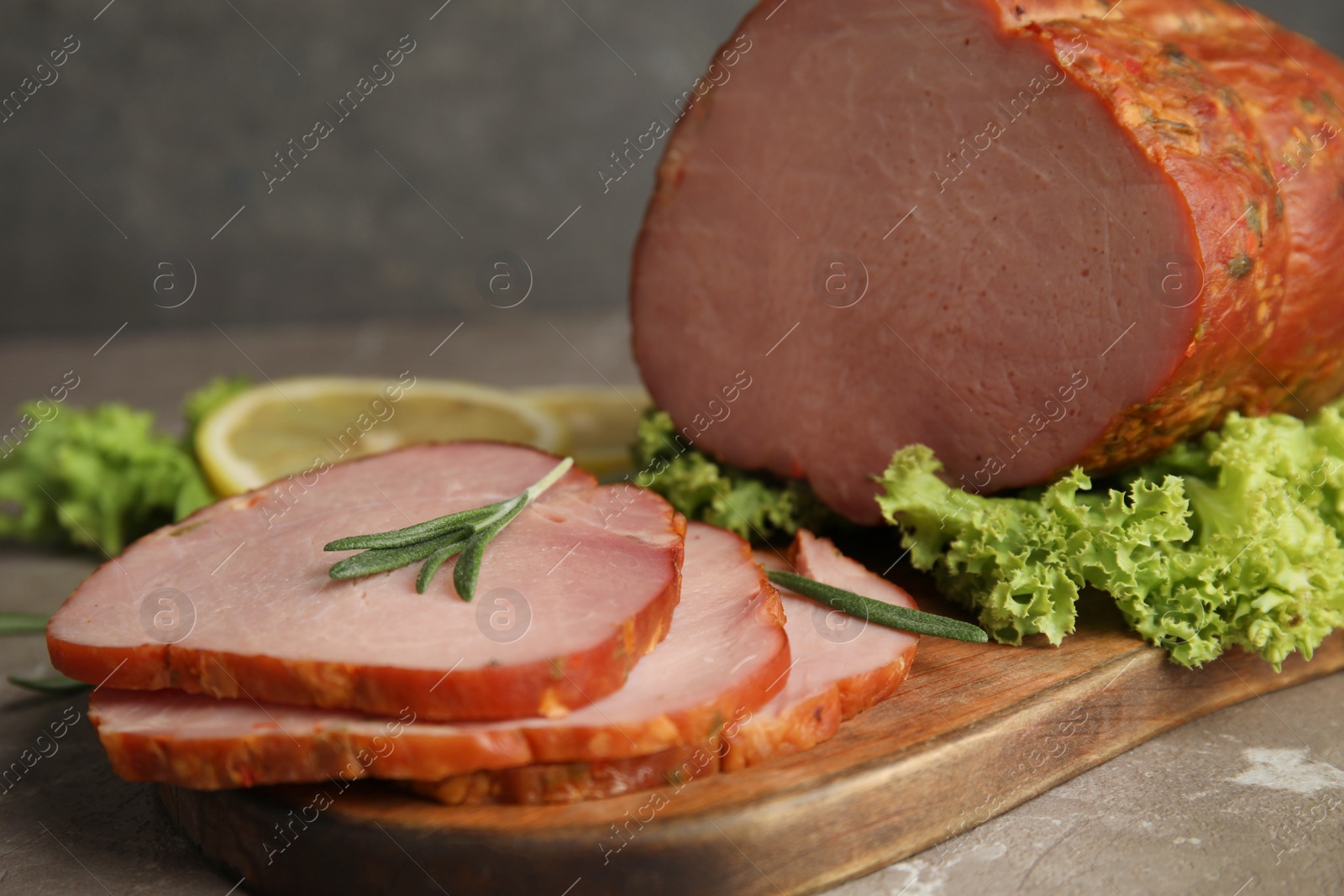 Photo of Delicious ham served on wooden board, closeup