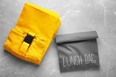 Lunch bags on gray background, top view