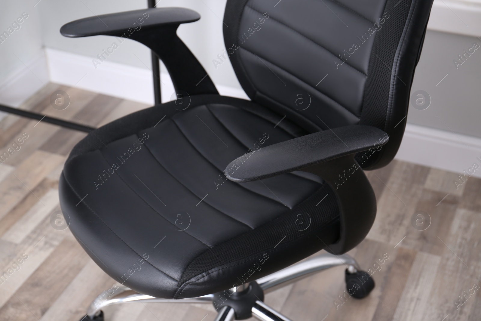 Photo of Modern comfortable office chair in room, closeup