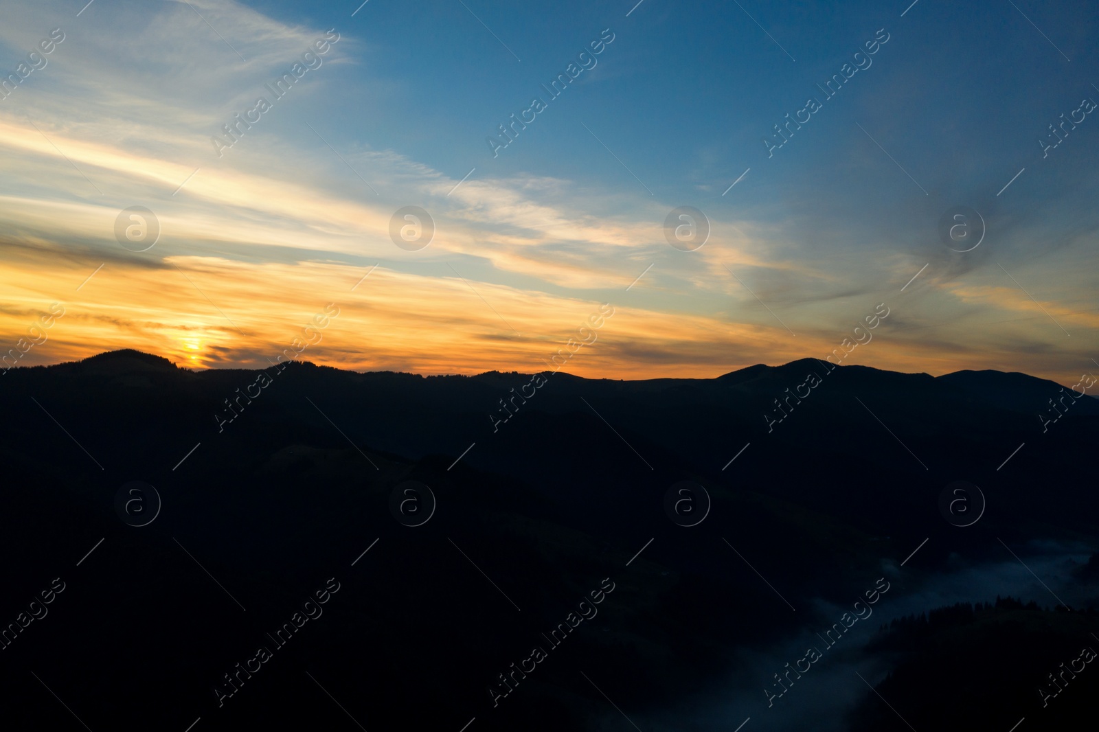 Image of Silhouette of mountain landscape at sunset. Drone photography