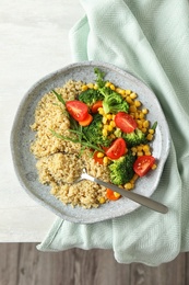 Plate with quinoa and different vegetables on table, top view