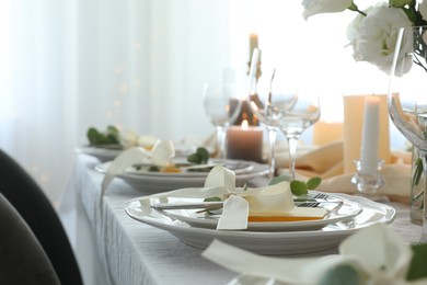 Festive table setting with beautiful floral decor in restaurant, space for text