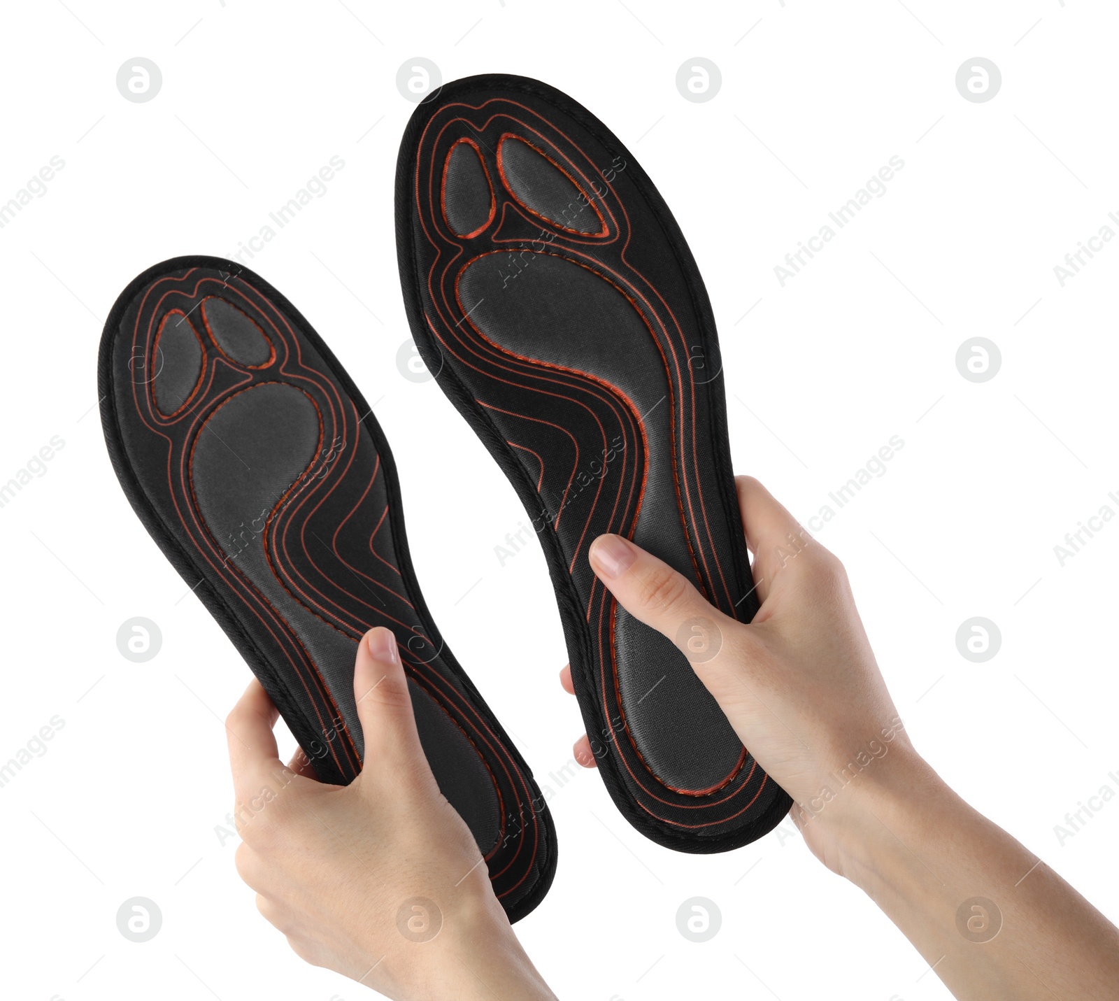 Photo of Woman holding pair of orthopedic insoles on white background, closeup