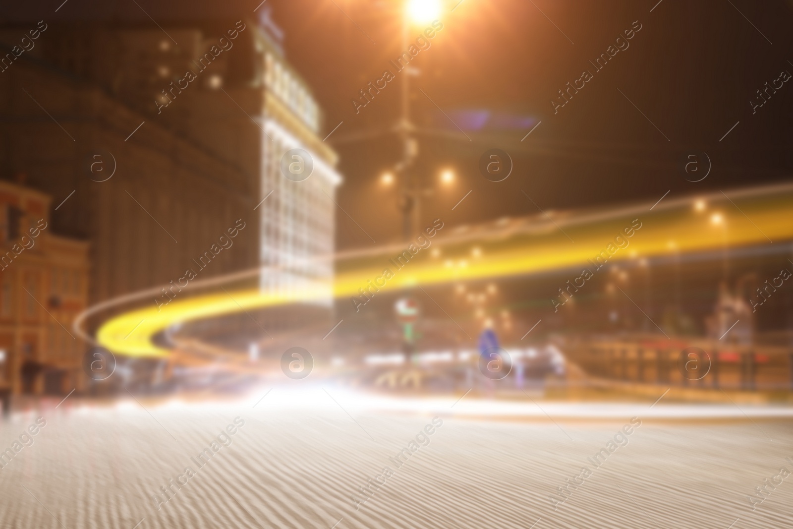 Image of Empty wooden surface and blurred view of night city