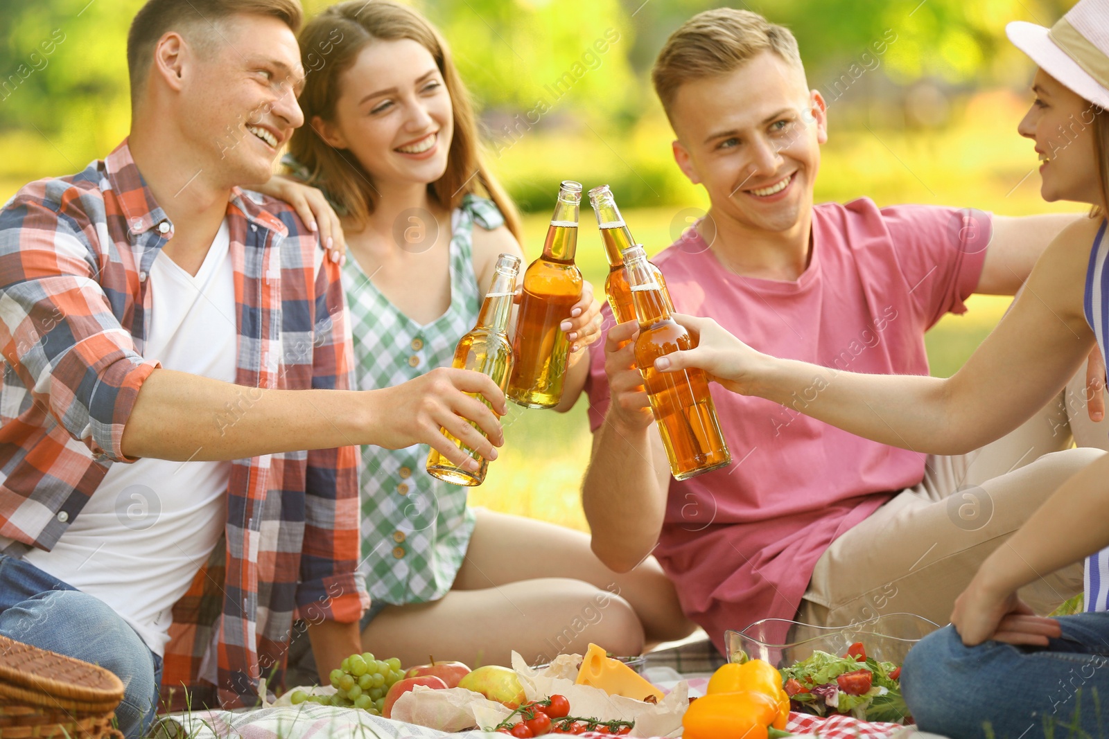 Photo of Young people enjoying picnic in park on summer day