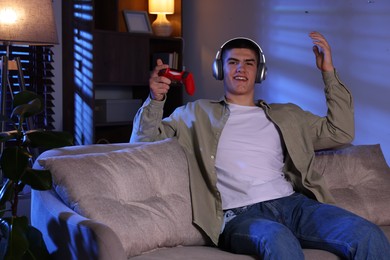 Man playing video games with controller at home