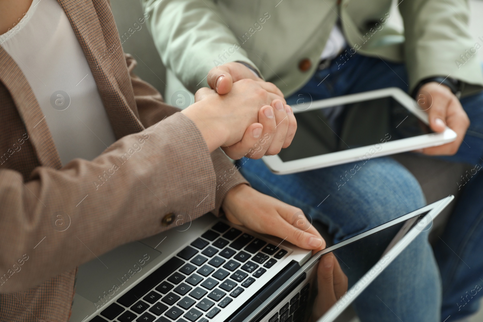 Photo of Business partners shaking hands after meeting, closeup