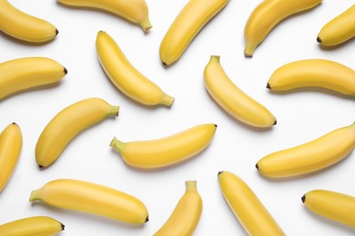 Sweet ripe baby bananas on white background, top view