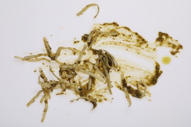 Photo of Smear of sauce and pasta on white background, top view