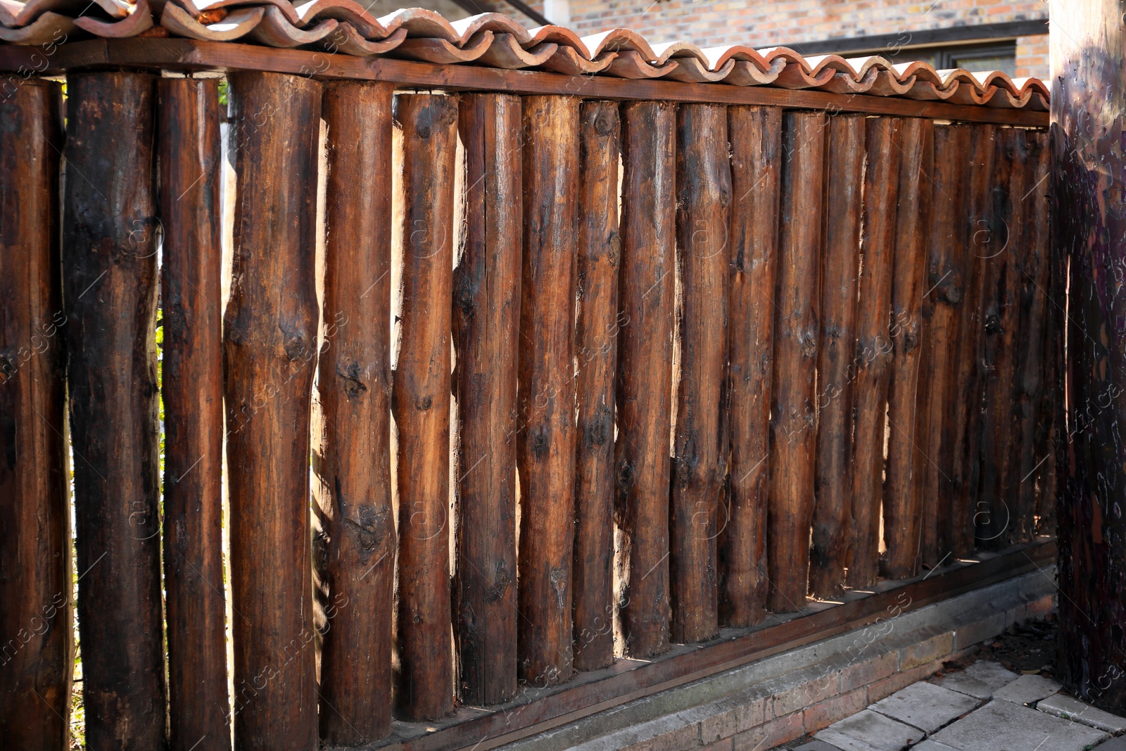 Photo of Brown wooden fence outdoors on sunny day