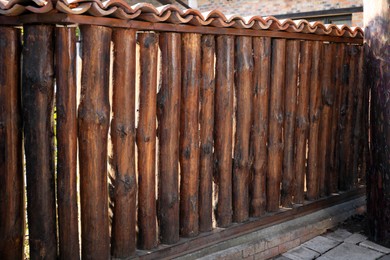 Brown wooden fence outdoors on sunny day