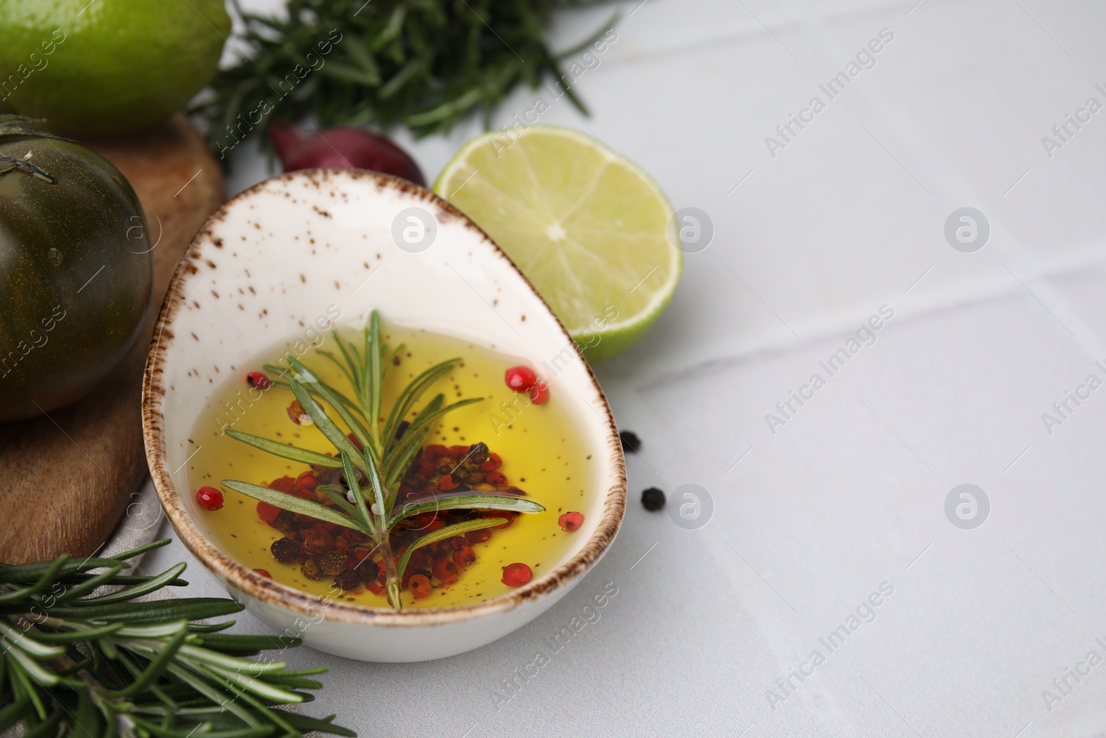 Photo of Tasty marinade and products on light tiled table, closeup. Space for text