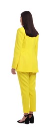 Businesswoman in yellow suit standing on white background