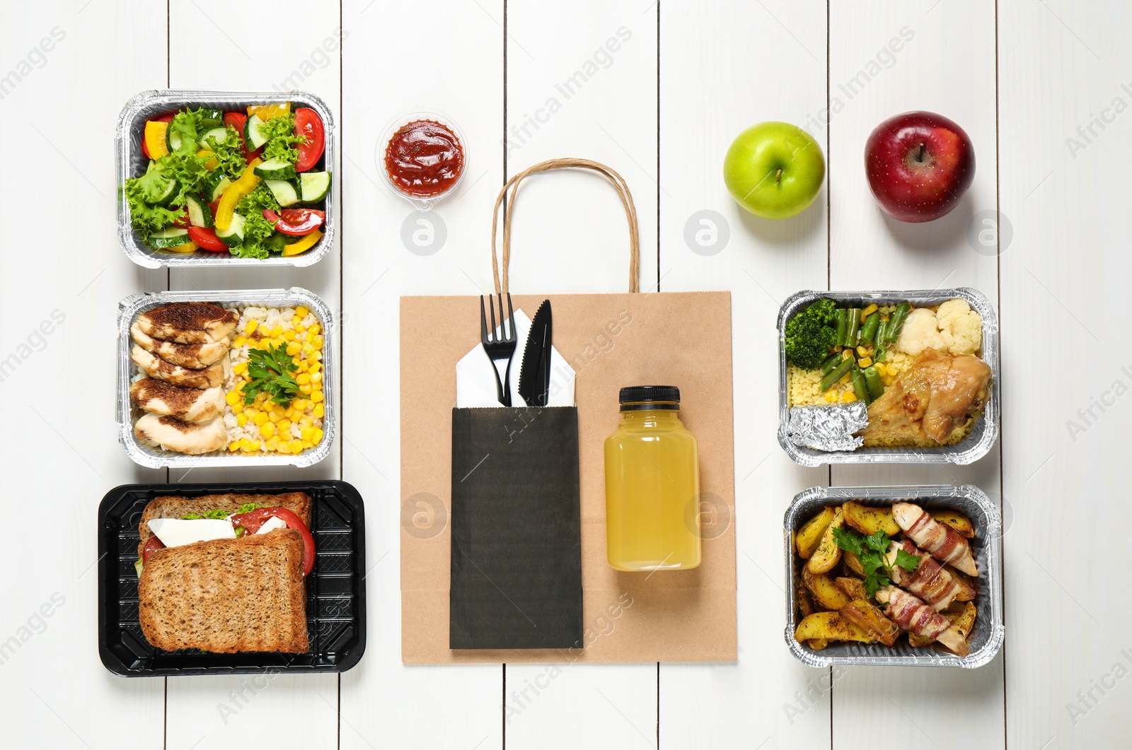 Photo of Lunchboxes on white wooden table, flat lay. Healthy food delivery