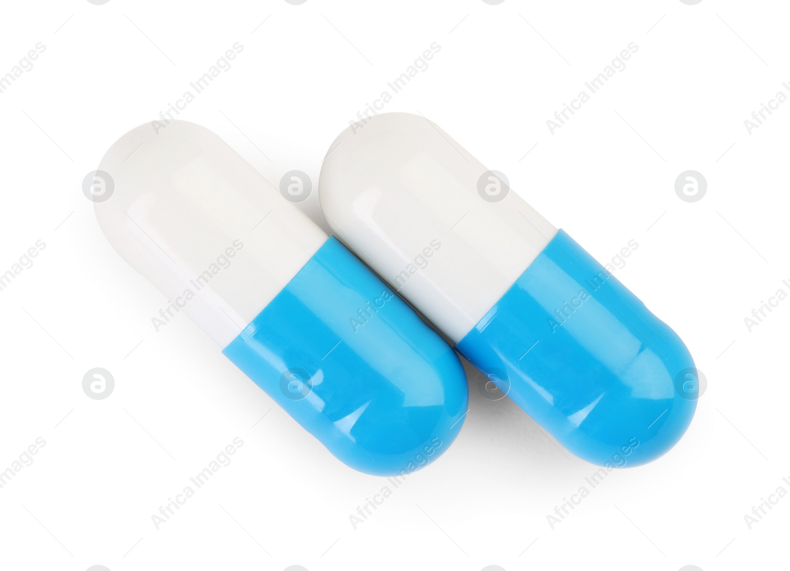 Photo of Two antibiotic pills isolated on white, top view