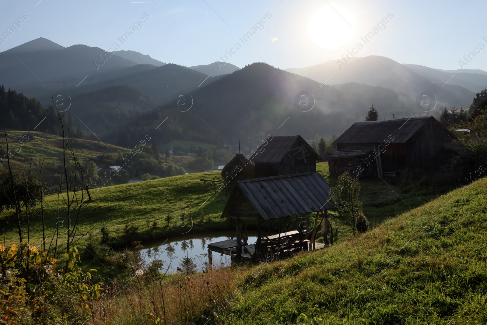 Photo of Morning sun shining over village in mountains