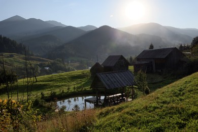 Photo of Morning sun shining over village in mountains