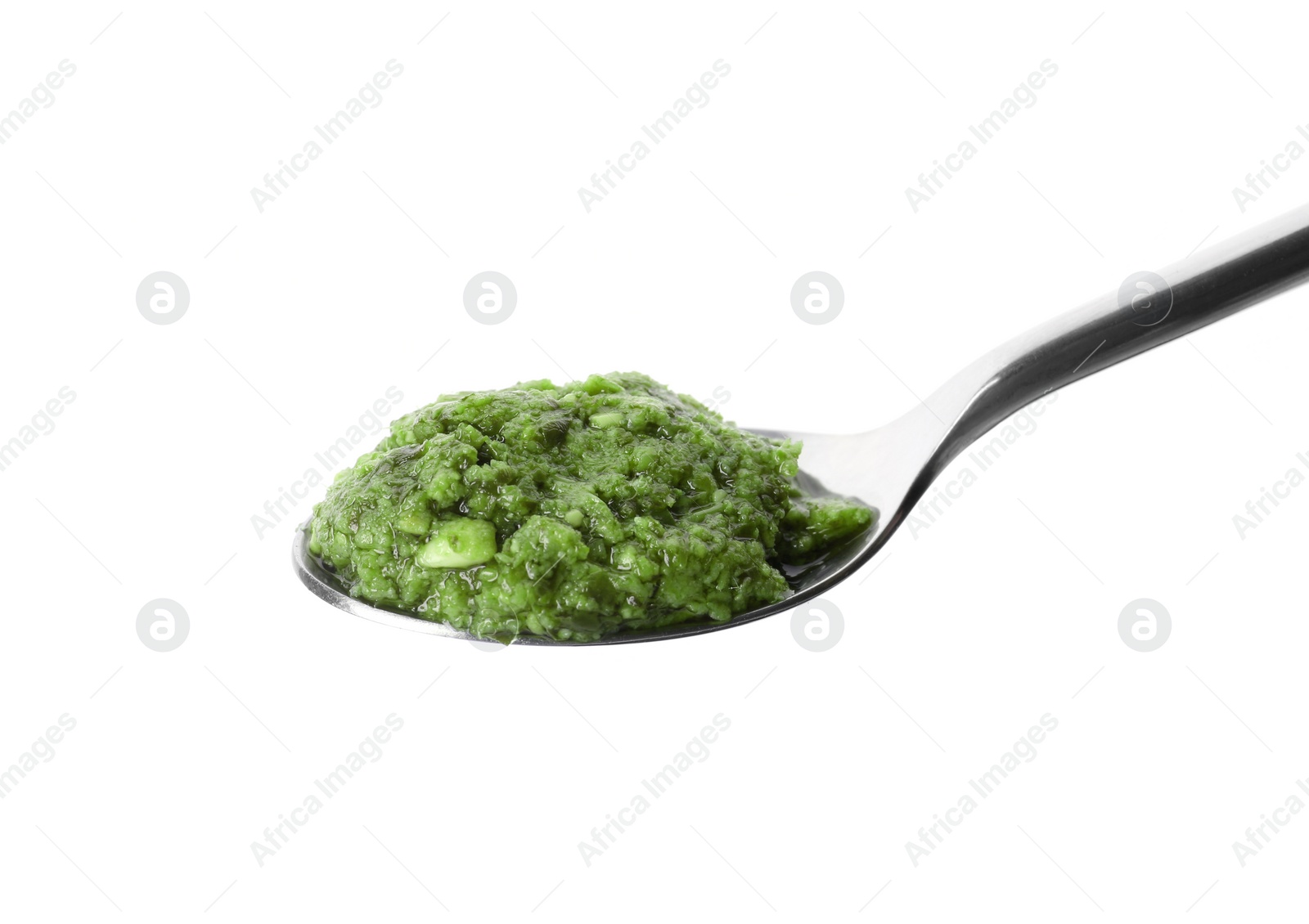 Photo of Spoon of tasty pesto sauce isolated on white