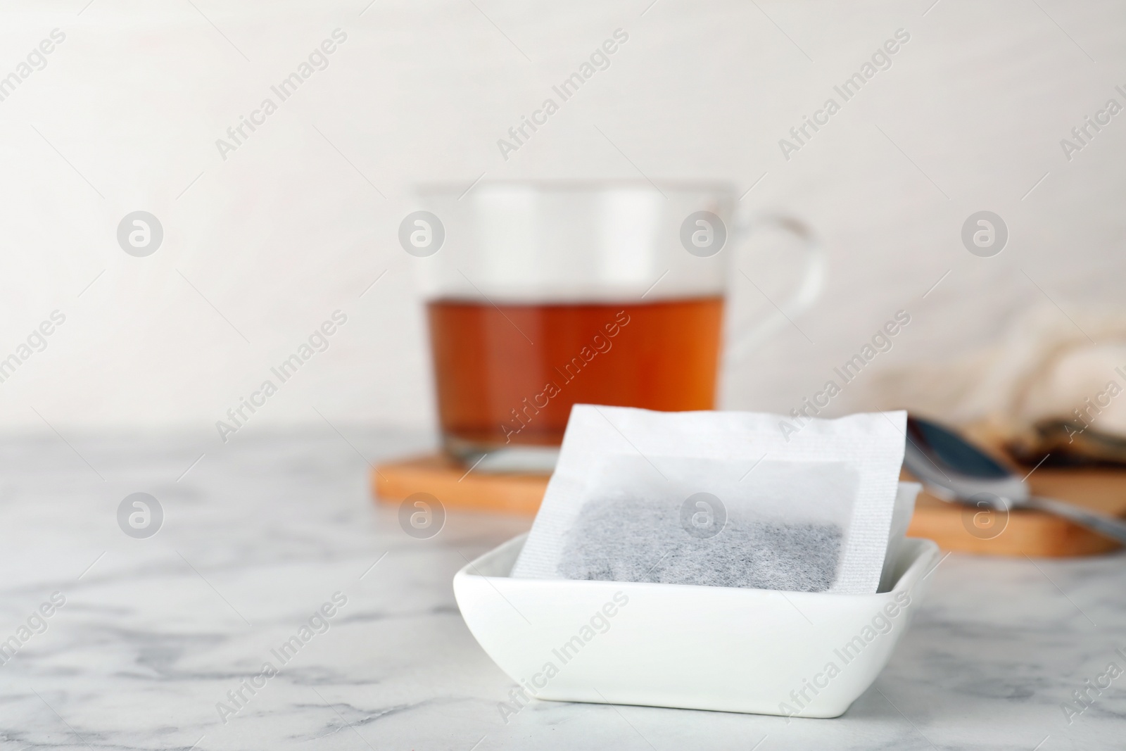 Photo of Bowl with tea bags on table. Space for text