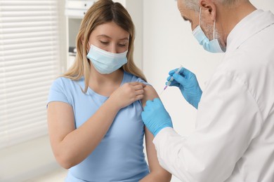 Photo of Doctor giving hepatitis vaccine to patient in clinic