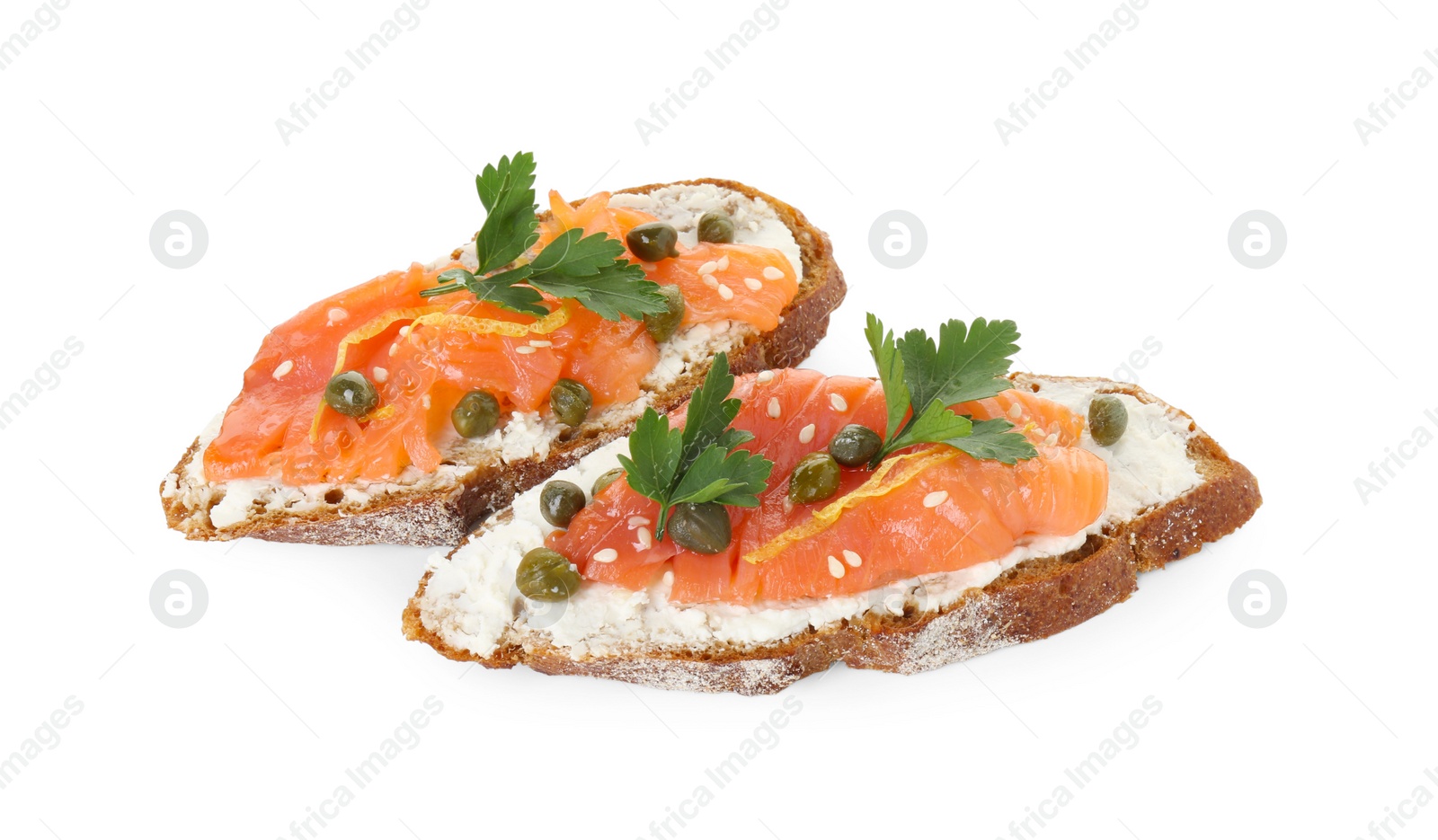 Photo of Tasty canapes with salmon, capers and cream cheese isolated on white