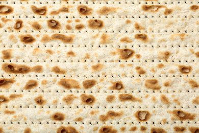 Photo of Traditional Matzo as background, top view. Pesach (Passover) celebration